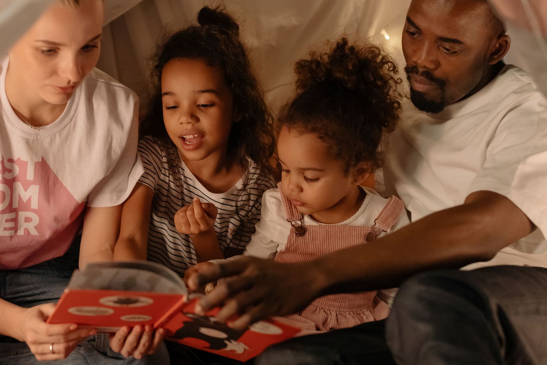 A family reading a picture book together