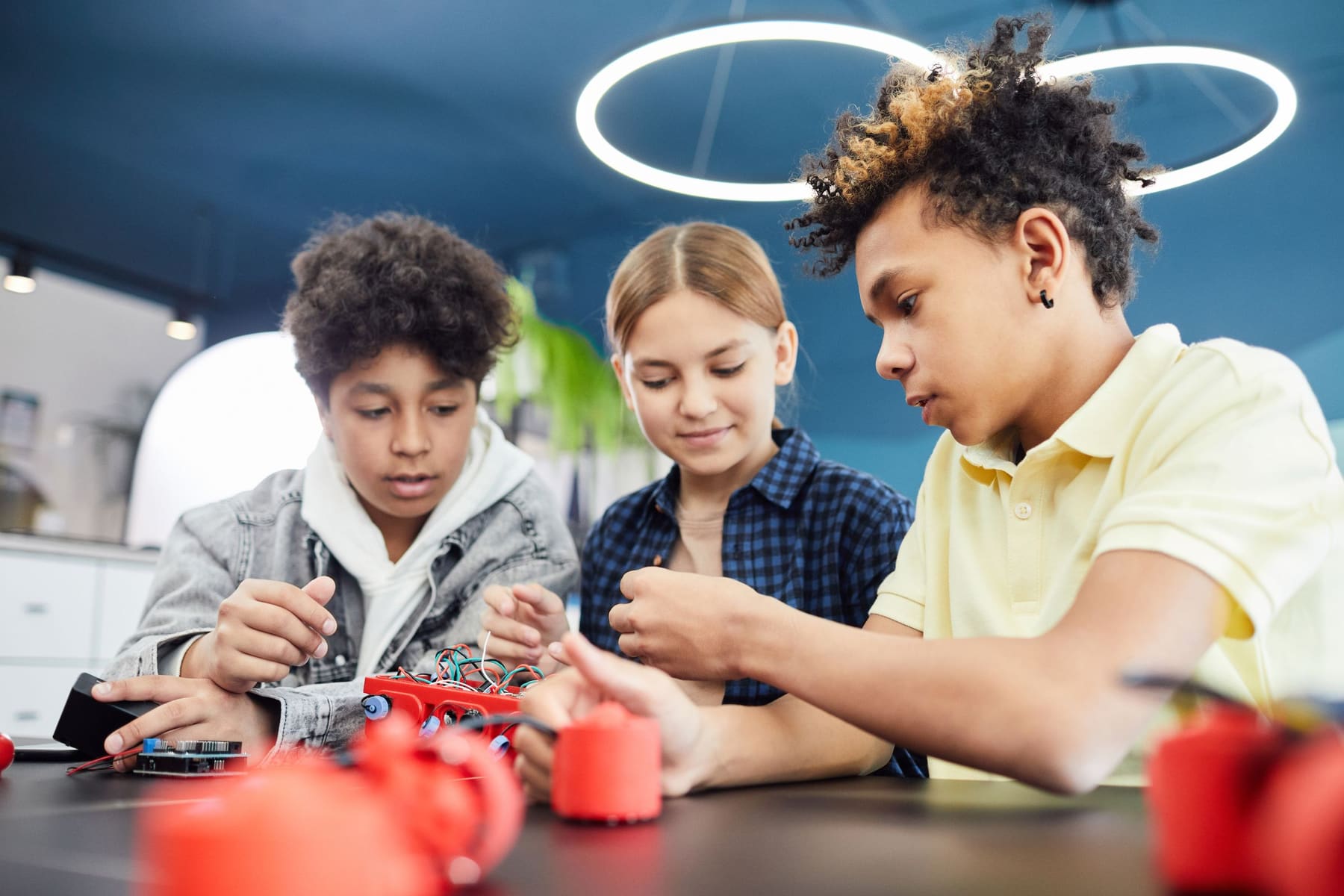 Teenagers working together on a robotics project