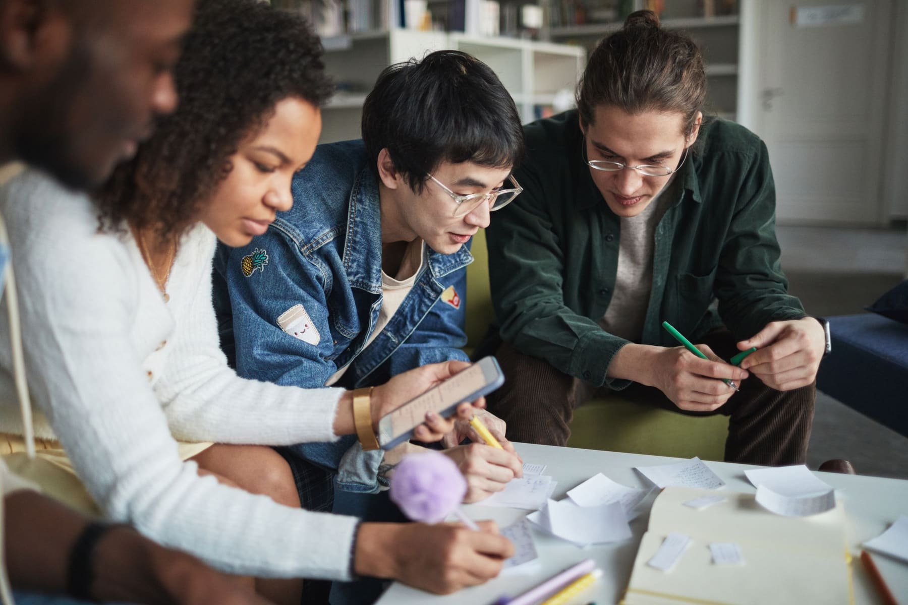 Students collaborating on a project around a table